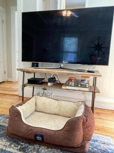 a living room with a couch and a large tv at Arlies Digs One Block To Willard Beach in South Portland