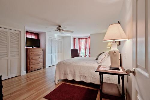 a bedroom with a bed and a table with a lamp at Back Cove - Large Sunny 2 Bedroom Condo in Portland
