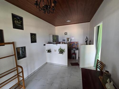 a living room with white walls and a table at Hotel Angel Inn Beach in Trincomalee