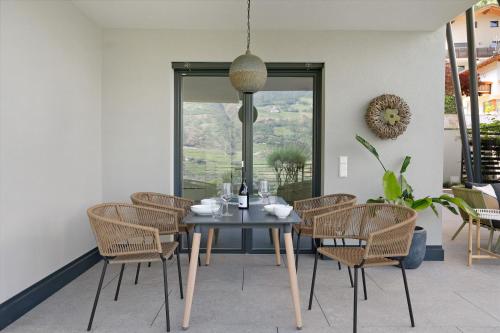 a dining room with a table and chairs at New Opening Vinea Guesthouse in Cornedo all'Isarco