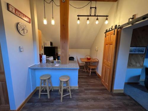 a kitchen with a blue island in a room at Summit Haus Golf and Liftside Penthouse in Carrabassett