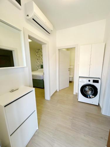 a kitchen with a washing machine in a room at Apartments Vinka in Jelsa