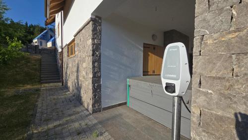 a parking meter on the side of a building at Komforna planinska kuća za odmor in Mrkopalj