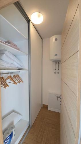 a walk in closet with a glass door at Komforna planinska kuća za odmor in Mrkopalj