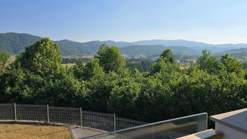 a view of trees and mountains from a house at Komforna planinska kuća za odmor in Mrkopalj