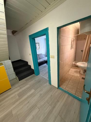 a room with a door and a bathroom with a sink at Apartment in Old Town with parking in Mostar
