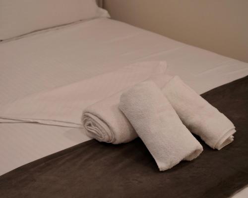 a pile of towels sitting on a bed at Sofra e Vjeter Restaurant and Guesthouse in Bregu i Lumit