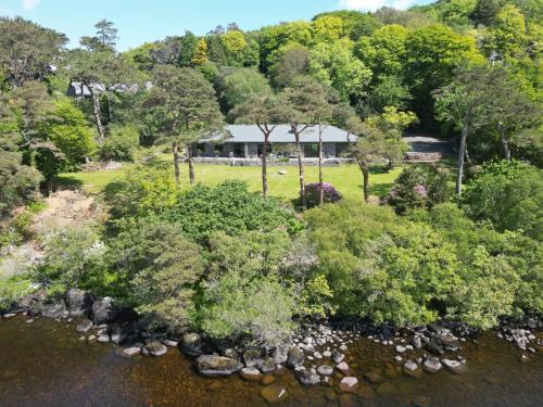 an aerial view of a park with trees and a river at Caragh Lake House - Lakefront Escape and Sauna in Killorglin