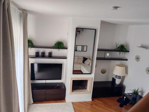 a living room with a mirror and a television at Manin Private SPA, Luxury Apartment very close to the sea, with beach umbrella and deckchairs included in Pescara