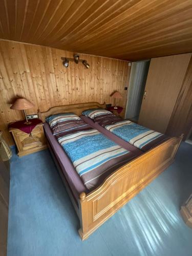an overhead view of a wooden bed in a room at Ferienwohnung Bongartz in Einbeck