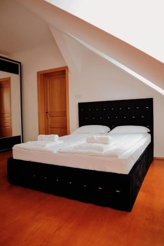 a large bed in a room with an attic at TOTO's apartment in Gheorgheni