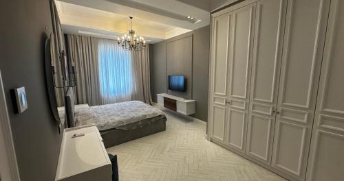 a bedroom with a bed and a television in it at Buzovna Private Seaside Villa in Baku