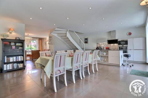 a kitchen and dining room with a table and chairs at Les ormelles in Montreuil-sur-Ille