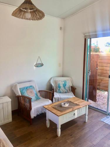 a living room with a table and two chairs at Posada Agua Marina in La Paloma
