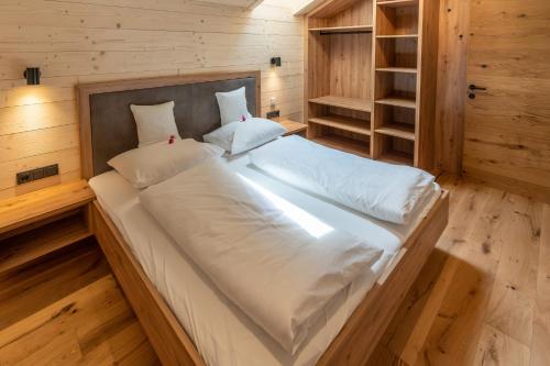a bedroom with a large bed in a wooden room at Madlhof in Himmelreich