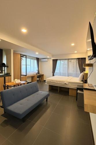 a living room with a couch and a bed at Alzeto Coliving in Legian