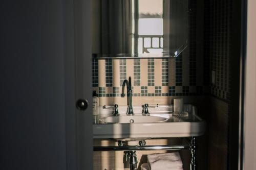 a bathroom with a sink and a mirror at Les Bassans in Perros-Guirec