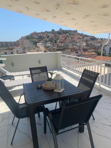 a black table and chairs on a balcony with a view at Vista Kavala Center in Kavála