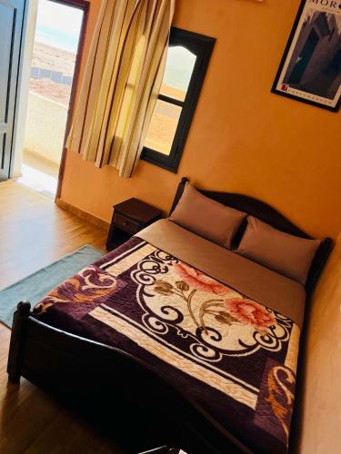 a bedroom with a bed in a room with a window at Hagounia hotel in Tan-Tan