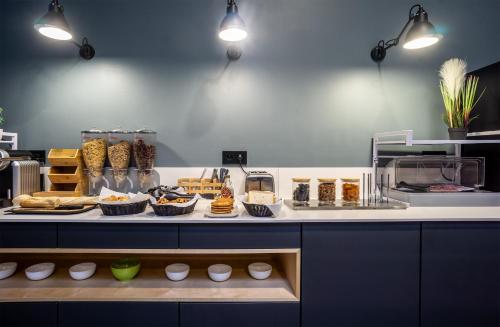 a kitchen with a counter with food on it at City Résidence Ivry in Ivry-sur-Seine