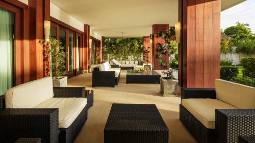 a patio with couches and chairs on a building at Under the Stars Luxury Apartment in Boracay