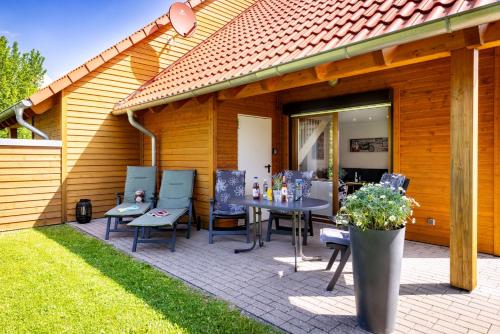 a patio with a table and chairs on it at Premiumferienhaus Vanua in Hasselfelde