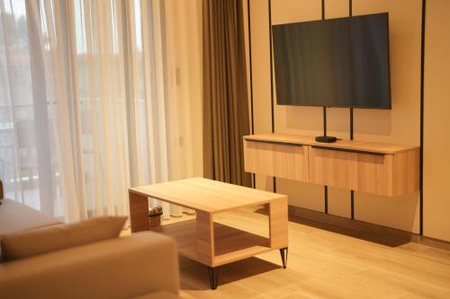 a living room with a tv and a coffee table at Sunrise Luxury Apartments in Fanárion
