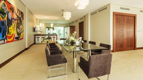 a dining room with a glass table and chairs at Under the Stars Luxury Apartment in Boracay