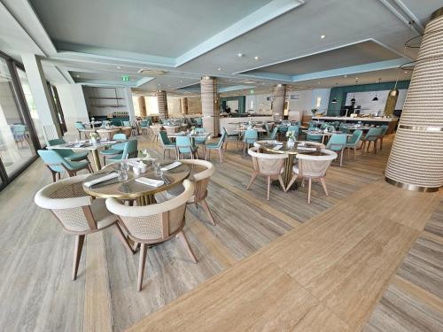 a restaurant with tables and chairs and a bar at Amadria Park Grand Hotel 4 Opatijska Cvijeta in Opatija