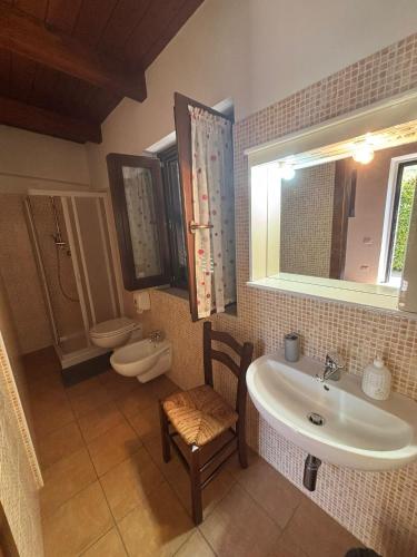 a bathroom with a sink and a toilet at B&B Da Fiorò in Massignano