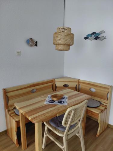 a wooden table and chairs in a room at Haus Troja in Warnemünde