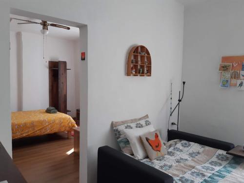 a living room with a couch and a bed at Hiša Tarka in Dobrovnik