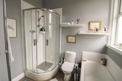 a bathroom with a shower and a toilet at Chertsey Mount Townhouse, Carlisle in Carlisle