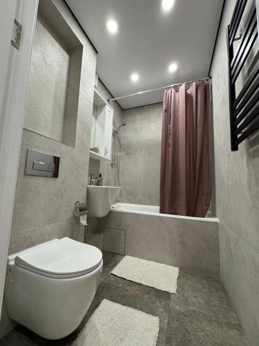 a bathroom with a toilet and a sink and a shower at Modern 3-Room Apartment in Râșcani, Chișinău! in Chişinău