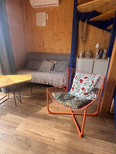 a room with a bed and a chair and a table at Morska 2K in Łukęcin
