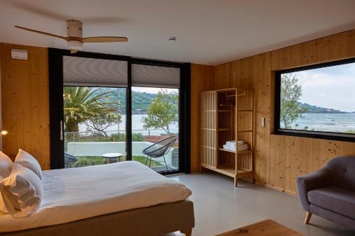a bedroom with a bed and a large window at Maison Laida in Ibarrangelu