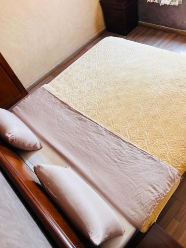 a bed with two pillows on top of it at Hagounia hotel in Tan-Tan