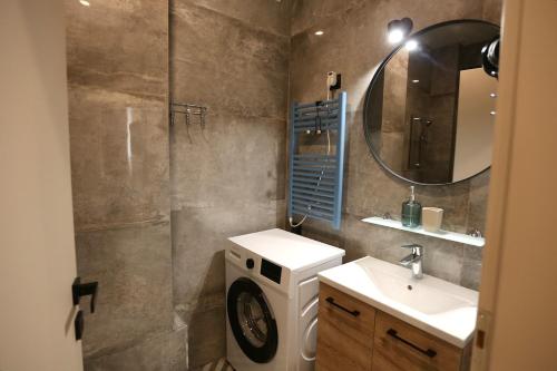a bathroom with a sink and a washing machine at Loutraki Garden in Loutraki