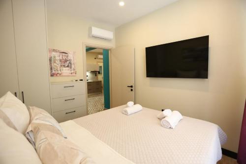 a bedroom with a bed with two towels on it at Loutraki Garden in Loutraki