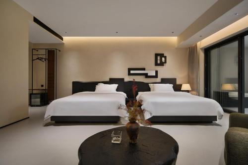Una cama o camas en una habitación de JIYU Hotel