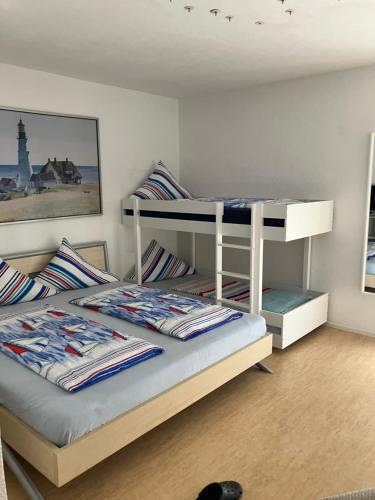 a bedroom with two bunk beds in a room at Gästehaus Tante Tienchen 7 Minuten zu Fuss zum Europa Park , plus kostenloses Parkplatzticket Rulantica ,alle unsere Suiten haben einen Balkon in Rust