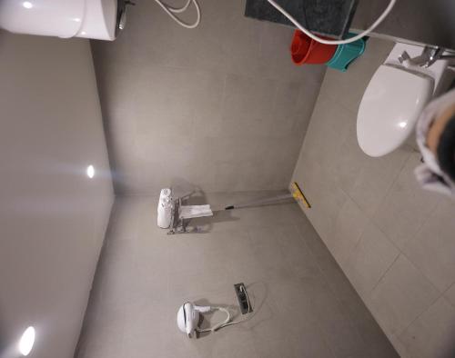 an overhead view of a bathroom with a toilet and sink at Hotel Royal Galaxy Blest Park in New Delhi