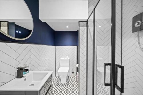 a bathroom with a toilet and a sink and a mirror at New! - The Most Central and Lux Whitby House - Hot-Tub in Whitby