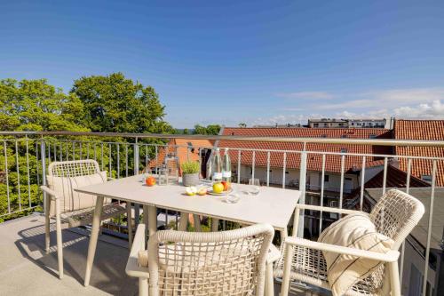 a white table and chairs on a balcony at Apartments Altes Konsulat in Stralsund