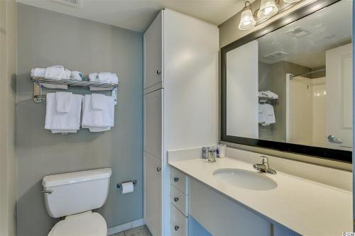 a bathroom with a toilet and a sink and a mirror at Spacious 2 Bedroom Oceanview Condo! 9th Floor Views! Oceans One 908 in Myrtle Beach