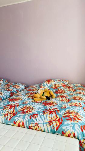 a teddy bear laying on top of a bed at Villa cosy in Fumel