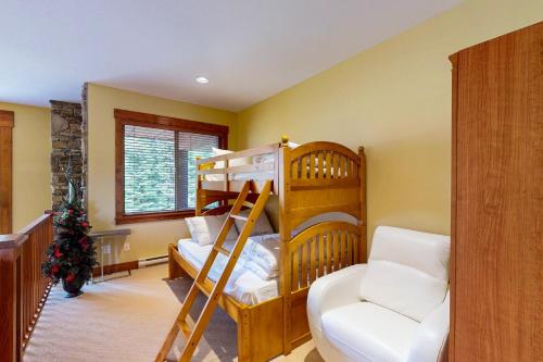two bunk beds in a room with a christmas tree at Snowbanks 2 in Big White
