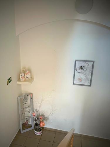a room with a white wall with a picture on it at Penzion U Hradeb in Znojmo