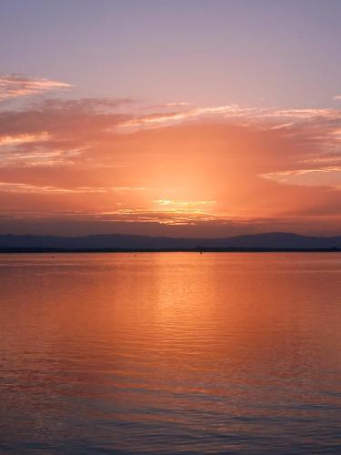 a sunset over a large body of water at Apartament Magnolia - Centrum in Nysa
