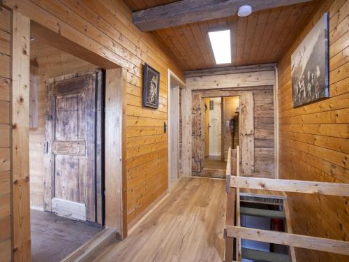 a hallway in a log cabin with a door and wooden walls at Holiday Home Hochzillertalblick by Interhome in Gattererberg